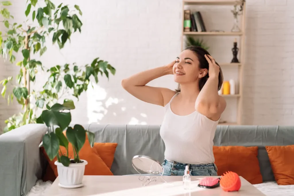 Girl massaging her healthy hairs. 