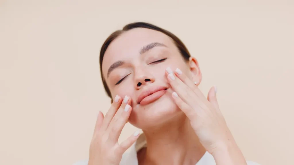 Girl applying serum on her face